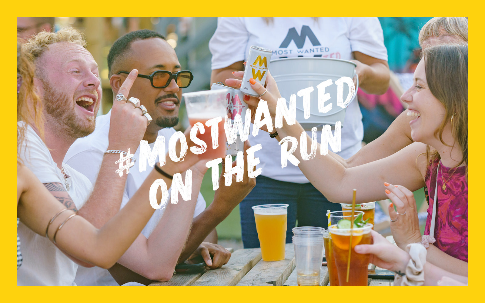 A group of laughing people with the words #MostWanted on the run written across the top