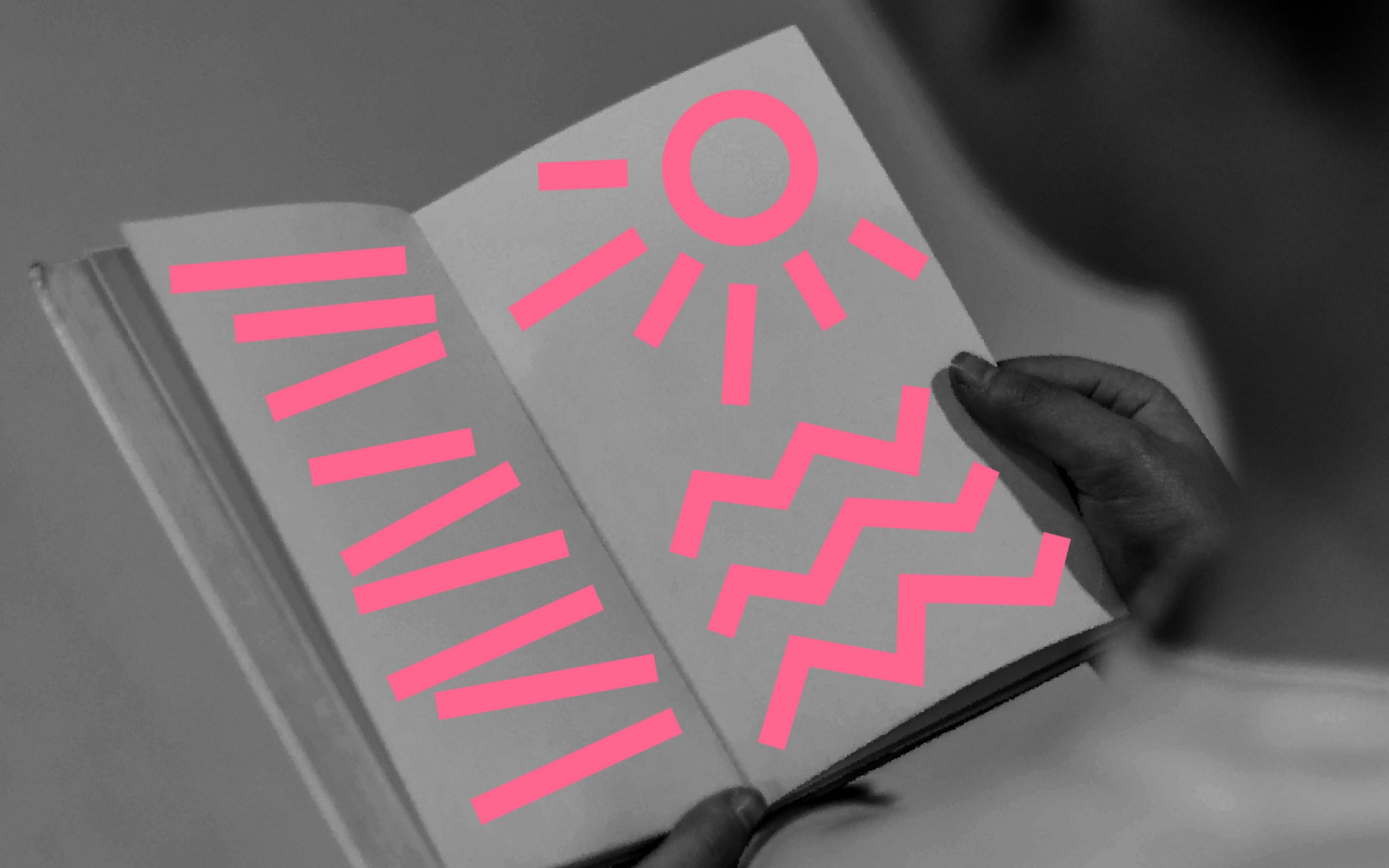 black and white image of an open book with neon pink scribbles